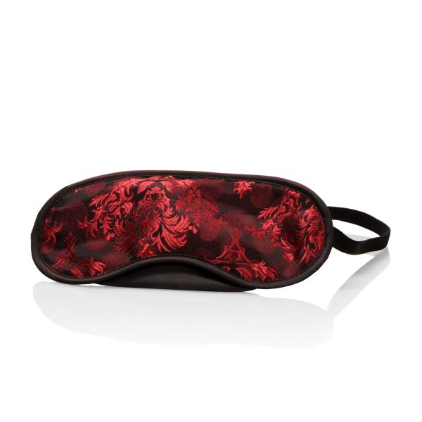 Red patterned eye mask on a white background